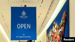 Workers hang a banner of APEC Summit 2022 at the Queen Sirikit National Convention Center where the APEC summit will be held in Bangkok, Thailand, Nov. 10, 2022. 
