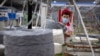FILE - A worker gathers cotton yarn at a textile manufacturing plant, as seen during a government organized trip for foreign journalists, in Aksu in western China's Xinjiang Uyghur Autonomous Region, April 20, 2021. 