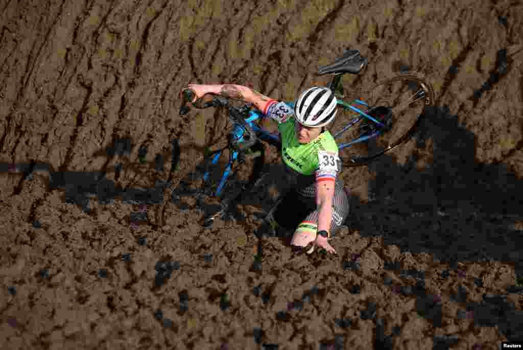 A competitor stumbles during the Junior women's race at the British Cyclocross championships near Milnthorpe, Britain, Jan. 15, 2023.