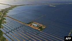 FILE - This photo taken on Oct. 6, 2021 shows solar panels at the site of solar energy projects developer Saurya Urja Company of Rajasthan Limited, in the northern Indian state of Rajasthan. (Photo by Sajjad HUSSAIN / AFP)