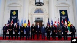 FILE - President Joe Biden, center, poses for a photo with Pacific Island leaders, including Papua New Guinea Prime Minister James Marape (fifth from the right) on the North Portico of the White House in Washington, Sept. 29, 2022.