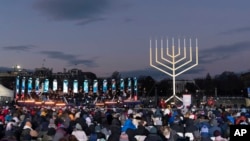 Attorney General Merrick Garland accompanied by Rabbi Levi Shemtov, speaks during the annual National Menorah Lighting in celebration of Hanukkah, on the Ellipse near the White House in Washington, Dec. 18, 2022. 