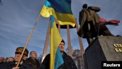 Activists and supporters of Ukrainian nationalist movements attend a rally to mark the 114th birth anniversary of Stepan Bandera, one of the founders of the Organisation of Ukrainian Nationalists (OUN), next to his monument in Lviv, Ukraine, Jan. 1, 2023. 