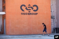 FILE - A logo adorns a wall on a branch of the Israeli NSO Group company, near the southern Israeli town of Sapir, Aug. 24, 2021.