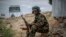 FILE - A fighter loyal to the Tigray People's Liberation Front (TPLF) mans a guard post on the outskirts of the town of Hawzen, then-controlled by the group but later re-taken by government forces, in the Tigray region of northern Ethiopia on May 7, 2021.