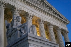 FILE - Light illuminates part of the Supreme Court building on Capitol Hill in Washington, Nov. 16, 2022.