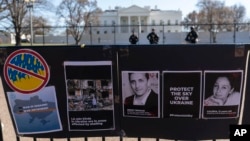 FILE - Signs and pictures of those killed, including journalist Brent Renaud, are displayed on a fence during a protest against Russia's invasion of Ukraine in Lafayette Park near the White House, March 13, 2022, in Washington. 