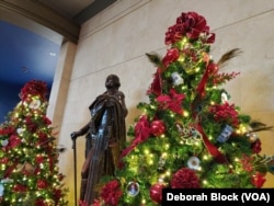 The Mount Vernon Estate in Alexandria, Virginia, formerly the home of George Washington, the first U.S. president, is a popular place to visit during the holidays. A statue of the president stands between two Christmas trees in the education center.