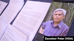 FILE - A pamphlet about Sombath Somphone sits on display at an event in Bangkok, Thailand, Dec. 15, 2022, marking the 10-year anniversary of his enforced disappearance in Laos. 