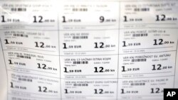 FILE - Prices of various books are displayed in both euro and kuna currencies in Zagreb, Croatia, Dec. 14, 2022. 