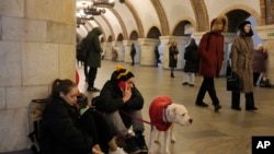 People rest in the subway station being used as a bomb shelter during a rocket attack in Kyiv, Ukraine, Dec. 29, 2022.