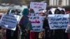 Women hold placards during a protest calling for their rights to be recognized, near the Shah-e-Do Shamshira mosque in Kabul, Nov. 24, 2022. Afghan women have been squeezed out of public life since the Taliban's return to power in August 2022.