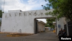 Police sit outside the facilities of La Prensa newspaper, a long-standing newspaper critical of President Daniel Ortega, after the Nicaraguan government took over the facilities to turn the space into a "cultural center," in Managua, Nicaragua Aug. 23, 2022.