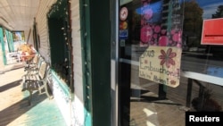 FILE - A "help wanted" sign is posted on the door of a bakery in Old Chelsea village, Quebec, Canada, Oct. 3, 2022. 