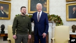 President Joe Biden and Ukrainian President Volodymyr Zelenskyy pose for a photo in the Oval Office of the White House, in Washington, Dec. 21, 2022.