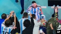 Argentina's Lionel Messi greets cheering fans after his team beat Croatia 3-0 in the World Cup in Lusail, Qatar, Dec. 13, 2022. 