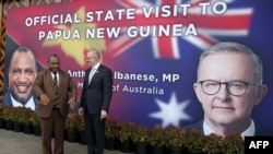 Papua New Guinea's Prime Minister James Marape (L) and his Australian counterpart Anthony Albanese pose for photos prior to their bilateral meeting in Port Moresby, Jan. 12, 2023.