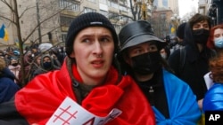 FILE - Activists rally in front of the Ukrainian Prosecutor General's Office protesting corruption inside the country's courts and demanding reforms, in Kyiv, Feb. 27, 2021.