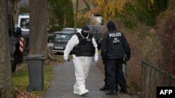 FILE - Police officers are seen in a street during a raid against members of a far-right group suspected of plans to overthrow the government, in Berlin, Germany, Dec. 7, 2022.