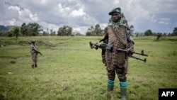 Members of the Patriotic Alliance for a Free and Independent Congo militia patrol during a surveillance tour in Kitshanga, eastern Democratic Republic of the Congo, on Dec. 11, 2022. 