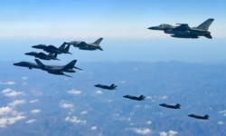 FILE - U.S. and South Korean jets fly over South Korea during a joint military drill called Vigilant Ace, in this handout photo released by the South Korean Defense Ministry, Dec. 6, 2017.