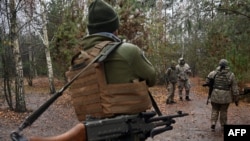 Ukrainian border guards stand at their fortified position near the Ukrainian border with Russia and Belarus, Nov. 3, 2022.
