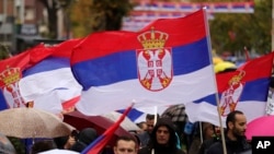 Kosovo Serbs wave Serbian flags in Mitrovica, Kosovo, on Nov. 6, 2022, as they protest Kosovo's decision to gradually ban Serbia-issued license plates. 