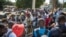 People gather outside the Thies, Senegal, courthouse on Thursday, when a judge dismissed a lawsuit by a fishermen’s collective against a fishmeal factory they accused of polluting their village and destroying their livelihoods.