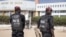 FILE - Police officers stand in front of the courthouse where opposition leader Ousmane Sonko is appearing for a hearing in Dakar, Senegal, Nov. 3, 2022. Senegalese journalist Pape Ale Niang was arrested after publishing articles about rape charges facing Sonko. 