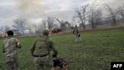 Ukrainian artillery unit members fire at Russian positions towards Kherson city, Oct. 28, 2022, in Ukraine's now Russia-annexed Kherson region.
