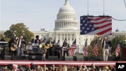 Comedians Jon Stewart, right, and Stephen Colbert, left, perform during their Rally to Restore Sanity and/or Fear on the National Mall in Washington, Saturday, Oct. 30, 2010.
