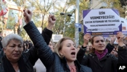 Turkish women protest in Ankara, Nov. 19, 2016, against a proposed law that would defer sentencing or punishment for child sexual assault in cases where there was no force and where the victim and perpetrator were later married. The placard reads: "We will not let you — rape cannot be legalized!"