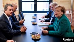 World Trade Organization (WTO) chief Roberto Azevedo President (L) and German Chancellor Angela Merkel hold talks on the sidelines of a conference organized by the Federation of German Industries (BDI) IN Berlin, Germany, Sept. 25, 2018. 