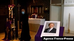 A photograph of Conservative British lawmaker David Amess, who was fatally stabbed, is pictured prior to a service at Saint Peter's Catholic Parish of Eastwood in Leigh-on-Sea in southeast England on Oct. 15, 2021