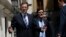Spain's Prime Minister Mariano Rajoy (L) reacts to a question from a reporter as he leaves after a session at the Senate in Madrid, Aug. 1, 2013.