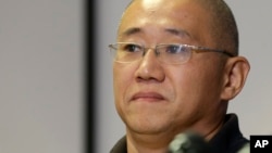 FILE - Kenneth Bae, who had been held in North Korea since 2012, waits to talk to reporters at Joint Base Lewis-McChord, Washington, Nov. 8, 2014.