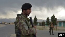 Afghan National Army (ANA) soldiers stand guard at a checkpoint near the a US military base in Bagram, some 50 kilometers north of Kabul, on April 29, 2021. 