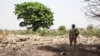 FILE - A Nigerian soldier stands amid the rubble of the Government Secondary School in Chibok, March 25, 2016. Schools are set to reopen in the region, where years of violence have decimated education. (C. Stein/VOA) 