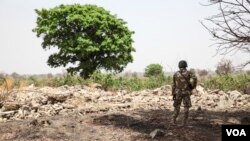 FILE - A Nigerian soldier stands amid the rubble of the Government Secondary School in Chibok, March 25, 2016. Schools are set to reopen in the region, where years of violence have decimated education. (C. Stein/VOA) 