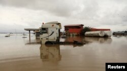 Vehicles are seen submerged in flood water at a petrol station in Lokoja, Nigeria, Oct. 13, 2022. 
