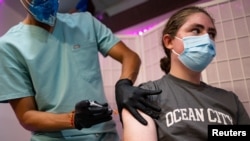 FILE - Sean Bagley, 14, receives the Pfizer-BioNTech COVID-19 booster vaccine targeting BA.4 and BA.5 Omicron subvariants at Skippack Pharmacy in Schwenksville, Pa., Sept. 8, 2022. 