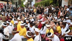 People gather for prayers at a memorial for victims killed in the 2002 Bali bombings during the 20th anniversary of the blasts that killed more than 200 people, in Kuta on the Indonesian resort island of Bali on Oct. 12, 2022. 