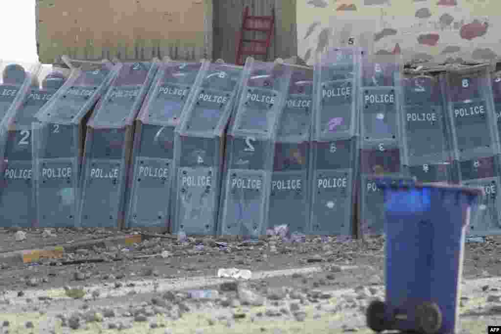 Iraqi security forces take cover during clashes with supporters of Shiite Muslim cleric Moqtada Sadr clash in Tahrir Square in the center of Iraq's capital Baghdad.