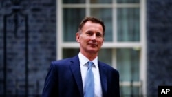 FILE - Jeremy Hunt leaves 10 Downing Street in London after he was appointed Chancellor of the Exchequer following the resignation of Kwasi Kwarteng, Oct. 14, 2022. 