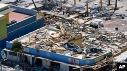 FILE - Business are seen in the wake of Hurricane Ian, in Fort Myers Beach, Florida, Sept. 29, 2022.