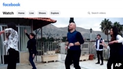 FILE - In this image from a video posted by the World Health Organization, Syria Facebook account on Dec. 15, 2020, Dr. Akjemal Magtymova, second from left, participates in a dance routine with WHO personnel.
