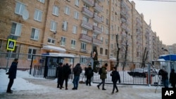 FILE - Journalists gather at the Moscow office of German public broadcaster Deutsche Welle in Moscow, Feb. 4, 2022. Russia's Foreign Ministry said it was shutting down the Deutsche Welle office and withdrawing its staff's accreditations, in retaliation for a German move against Russian state RT TV.