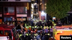 Rescue team and firefighters work at the scene of a deadly crowd surge during a Halloween festival in Seoul, South Korea, Oct. 30, 2022.