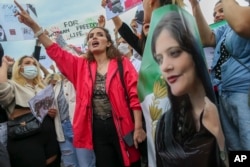 Women shout slogans during a protest against the death of Iranian Mahsa Amini, in Istanbul, Turkey, Oct. 2, 2022.