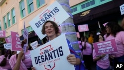 FILE - Supporters of Democratic candidate for governor Charlie Crist and Florida's Republican Gov. Ron DeSantis stand outside the Sunrise Theatre ahead of their debate, in Fort Pierce, Fla., Oct. 24, 2022.